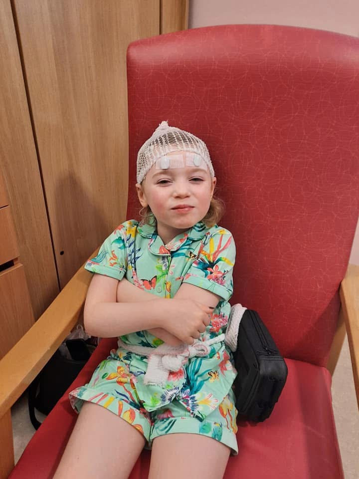 Olivia wearing an EEG cap during monitoring